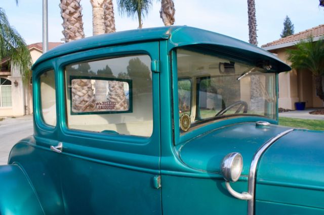 Green 1930 Ford Model A Coupe with White / Green interior