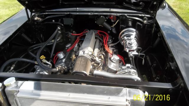Black 1957 Chevrolet Bel Air/150/210 with Red interior