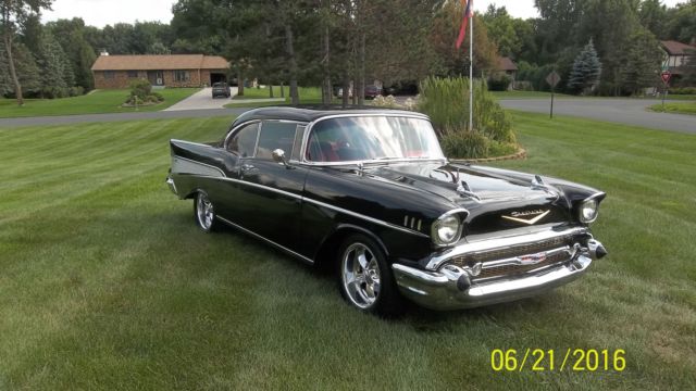Black 1957 Chevrolet Bel Air/150/210 with Red interior