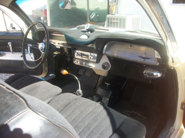 yellow 1962 Chevrolet Corvair coupe with Black interior