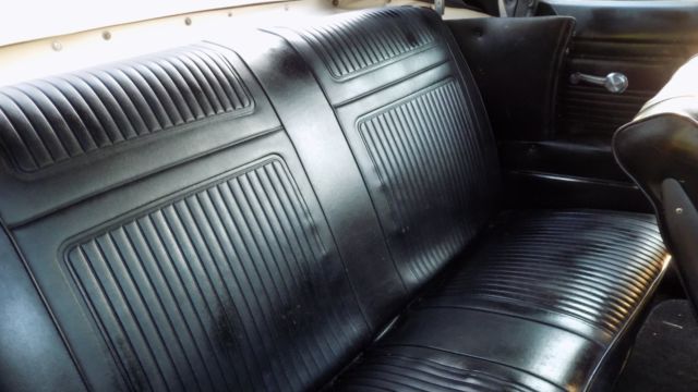 white 1966 Chevrolet Corvair Convertible with black interior