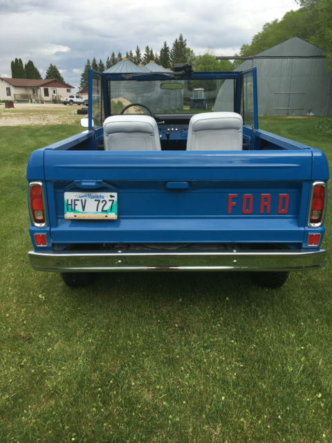 Blue 1971 Ford Bronco with white/gray interior