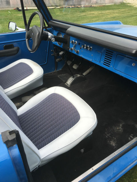 Blue 1971 Ford Bronco with white/gray interior