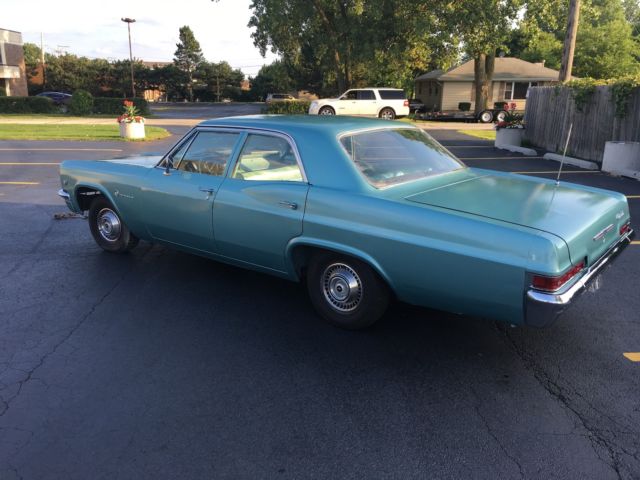 turquoise 1966 Chevrolet Impala Sedan with turquoise interior