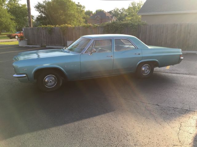 turquoise 1966 Chevrolet Impala Sedan with turquoise interior