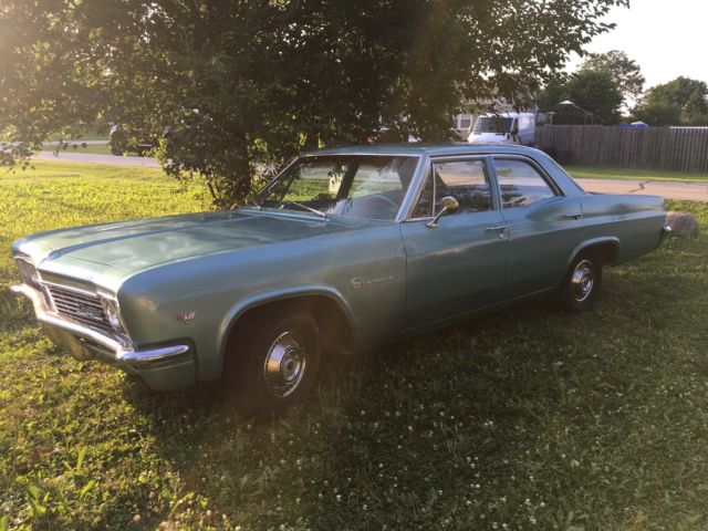 turquoise 1966 Chevrolet Impala Sedan with turquoise interior