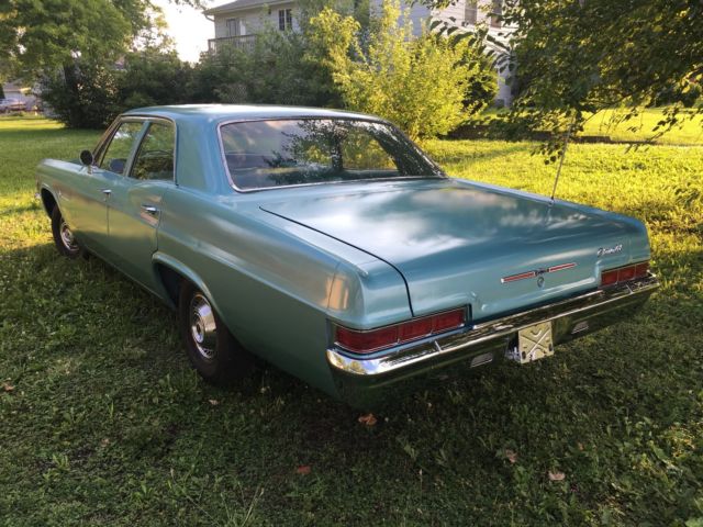 turquoise 1966 Chevrolet Impala Sedan with turquoise interior