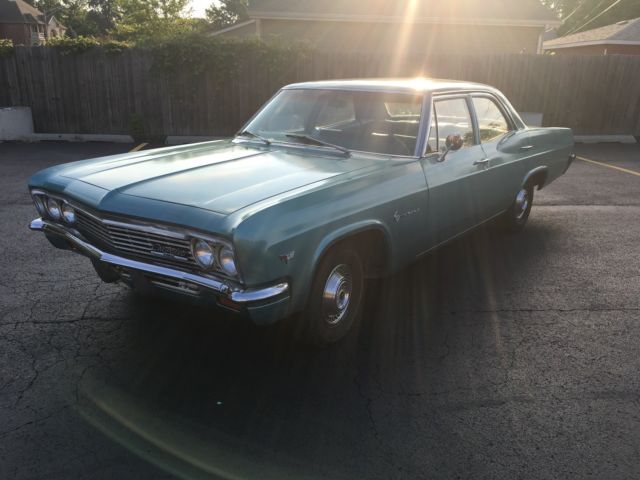 turquoise 1966 Chevrolet Impala Sedan with turquoise interior