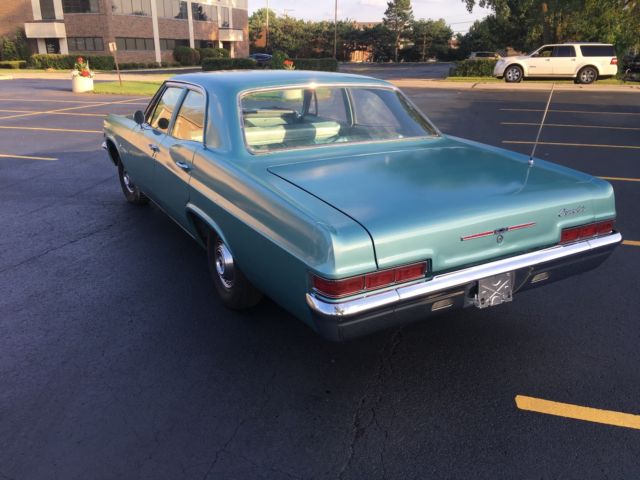 turquoise 1966 Chevrolet Impala Sedan with turquoise interior