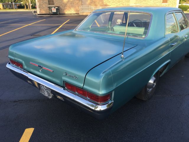 turquoise 1966 Chevrolet Impala Sedan with turquoise interior