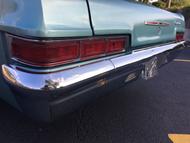 turquoise 1966 Chevrolet Impala Sedan with turquoise interior