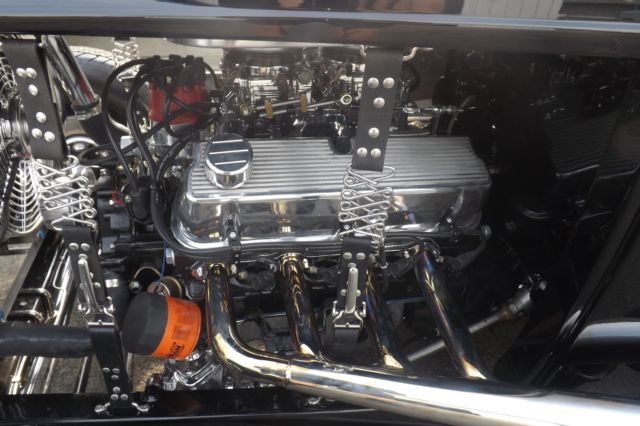 Black 1932 Ford Highboy Roadster Convertible with red leather interior