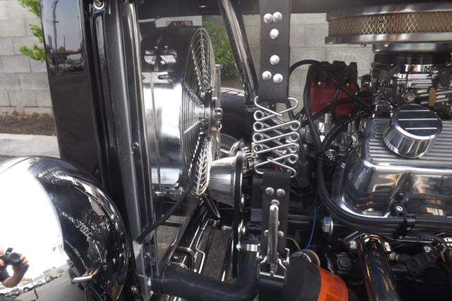 Black 1932 Ford Highboy Roadster Convertible with red leather interior
