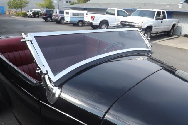 Black 1932 Ford Highboy Roadster Convertible with red leather interior