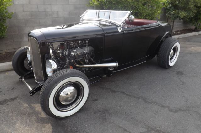 Black 1932 Ford Highboy Roadster Convertible with red leather interior