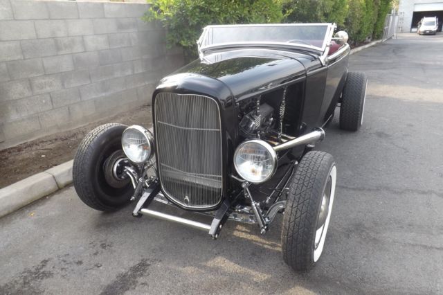 Black 1932 Ford Highboy Roadster Convertible with red leather interior