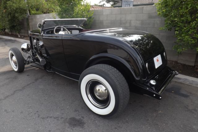 Black 1932 Ford Highboy Roadster Convertible with red leather interior