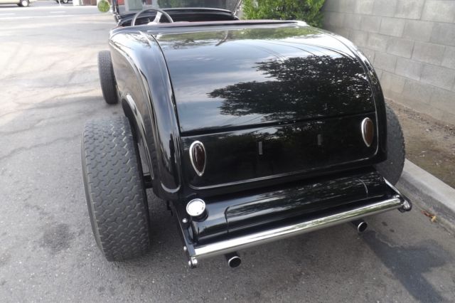 Black 1932 Ford Highboy Roadster Convertible with red leather interior