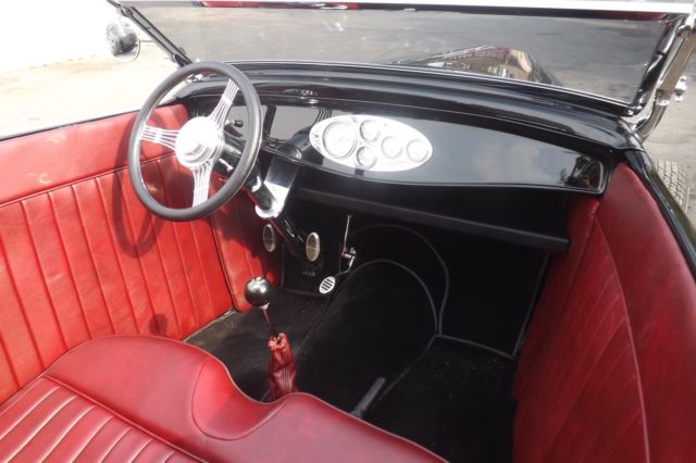 Black 1932 Ford Highboy Roadster Convertible with red leather interior