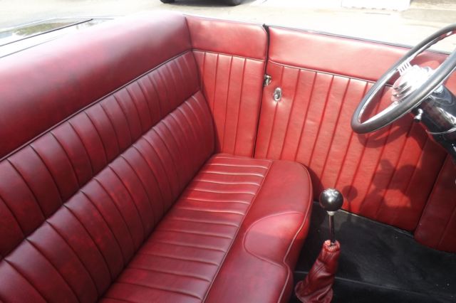 Black 1932 Ford Highboy Roadster Convertible with red leather interior