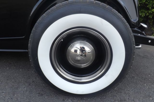 Black 1932 Ford Highboy Roadster Convertible with red leather interior