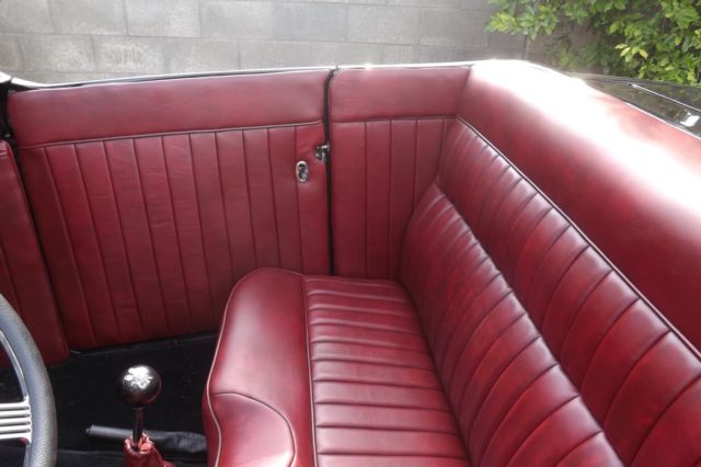 Black 1932 Ford Highboy Roadster Convertible with red leather interior