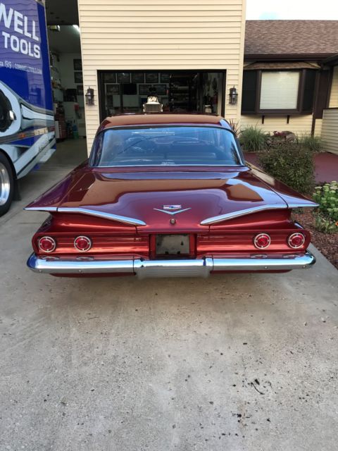 Red 1960 Chevrolet Impala Sedan with Blue interior