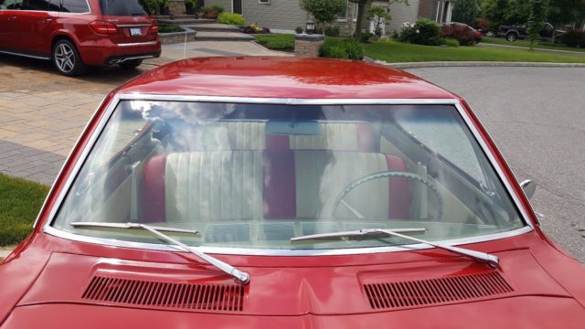 Red 1965 Chevrolet Corvair Sedan with White interior