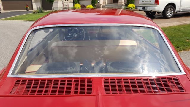 Red 1965 Chevrolet Corvair Sedan with White interior