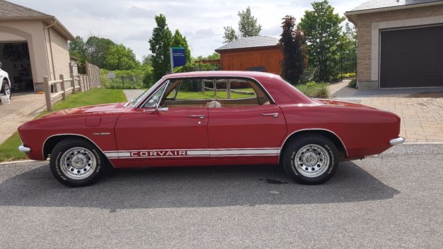 Red 1965 Chevrolet Corvair Sedan with White interior