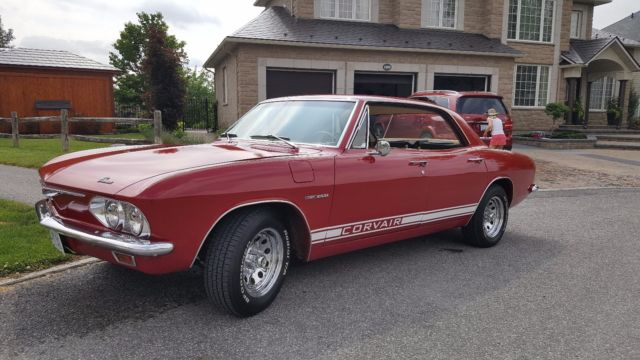 Red 1965 Chevrolet Corvair Sedan with White interior