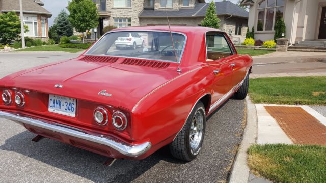 Red 1965 Chevrolet Corvair Sedan with White interior