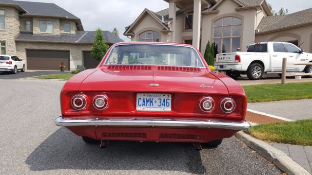 Red 1965 Chevrolet Corvair Sedan with White interior
