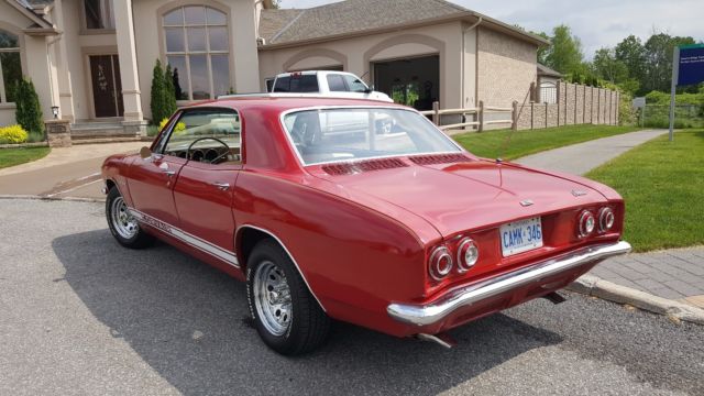 Red 1965 Chevrolet Corvair Sedan with White interior