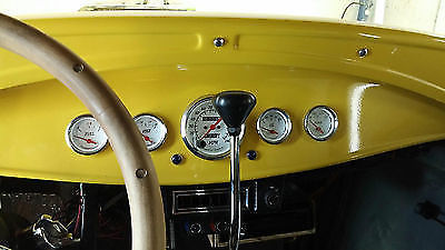 Yellow 1930 Ford Model A Sedan with Gray interior
