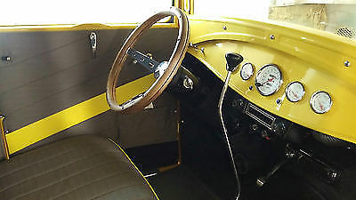 Yellow 1930 Ford Model A Sedan with Gray interior