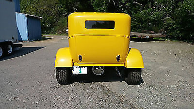 Yellow 1930 Ford Model A Sedan with Gray interior