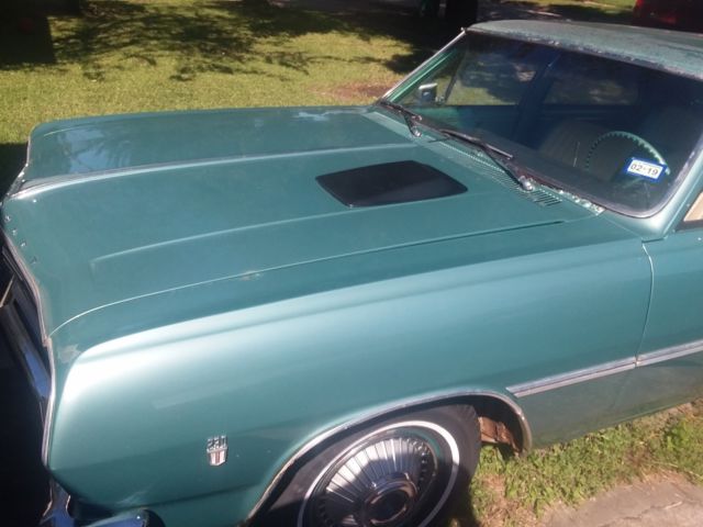 Green 1965 Chevrolet Chevelle Sedan with Teal interior